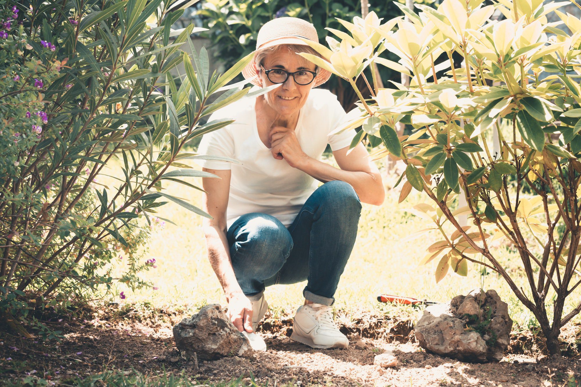 Senior woman gardening while she thinks about medicare advisors in her area.