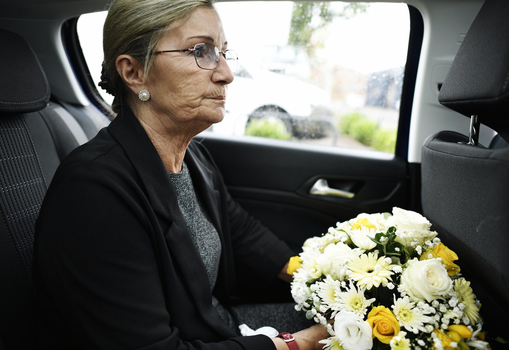 Sad widow on the way to the funeral understanding why she had Final Expense Insurance