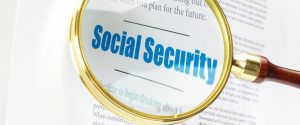 Social Security words in a book under magnifier - image